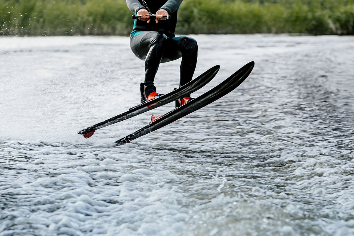 man waterskiing on lake behind